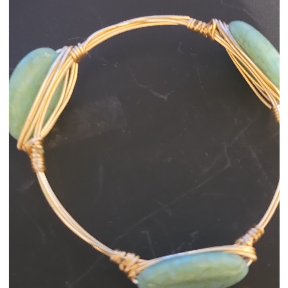 Colorful gold toned bangle with natural appearing stones
